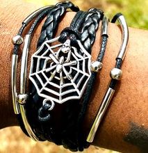 A multi-strand leather bracelet adorned with cobweb decorations